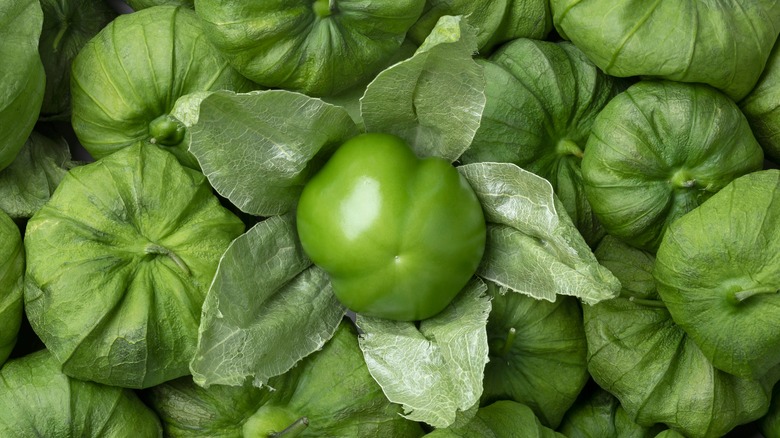 Unwrapped tomatillo in center of pile