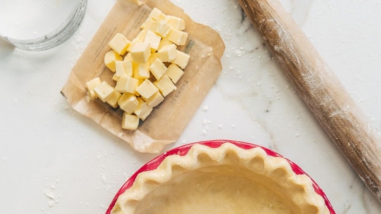 cubed cultured butter with pie crust and rolling pin