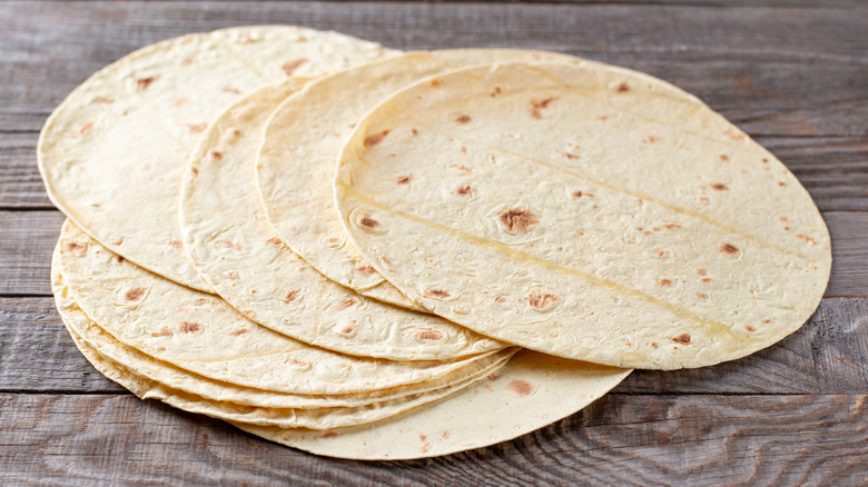 tortillas laid out on wooden surface