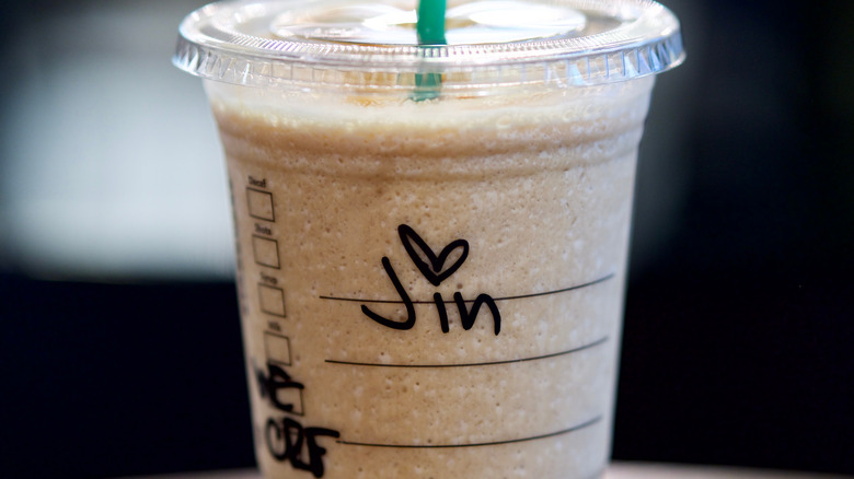 Starbucks grande cup on barista counter