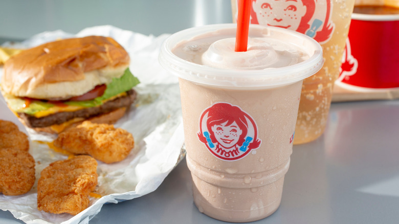 Wendy's burger, nuggets and frosty on table.