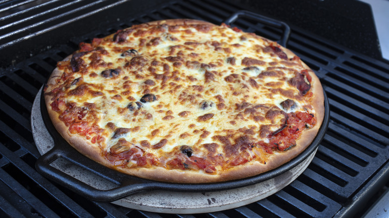 charred pizza on gas grill