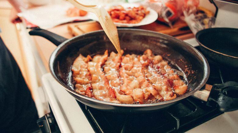 Frying bacon in a pan