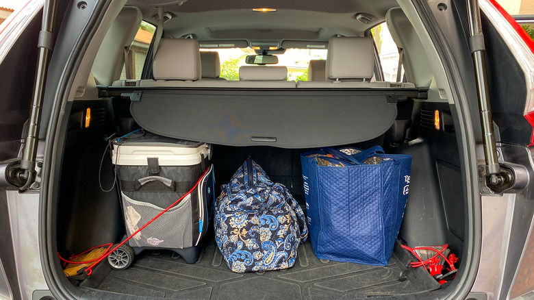 car trunk packed with cooler and bags