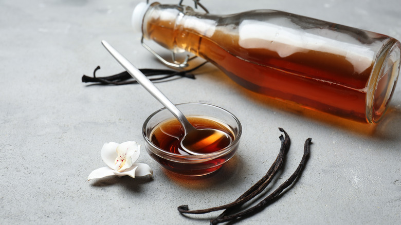 Vanilla extract bottle and bowl with spoon