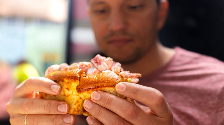Man holding a lobster roll