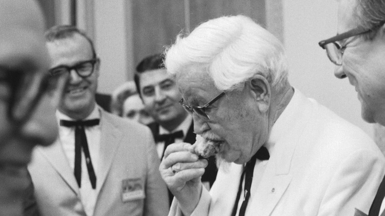 Harland Sanders eating fried chicken