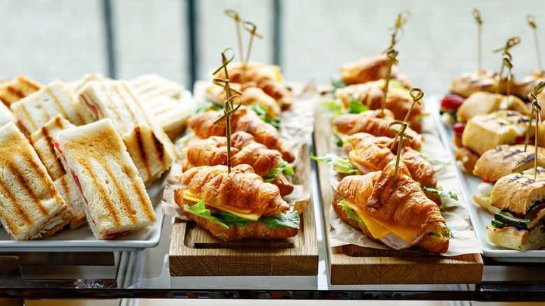 sandwiches sitting on tabletop platters
