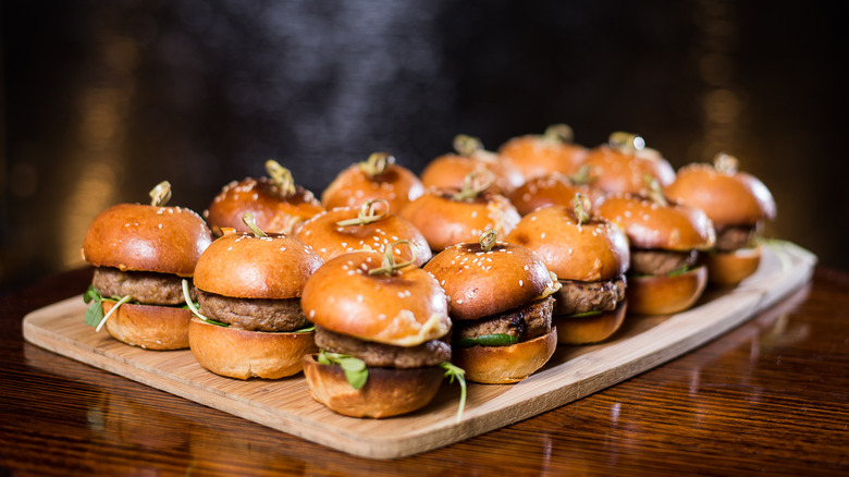 Wooden plate of mini burgers