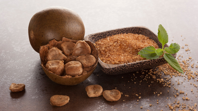 Monk fruit beside a bowl of sugar