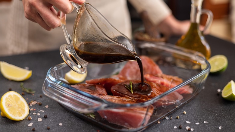 A marinade being poured over meat