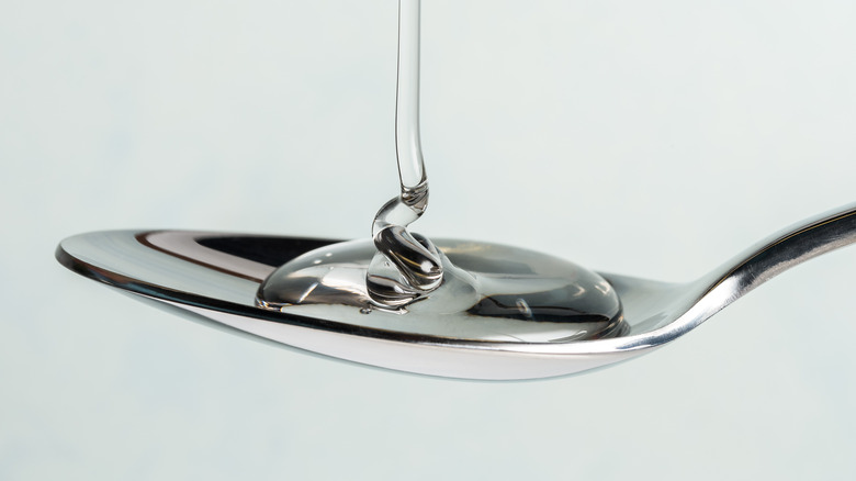 pouring corn syrup on a spoon