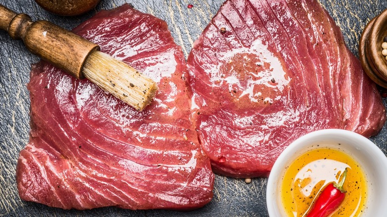 Tuna steaks being marinated 