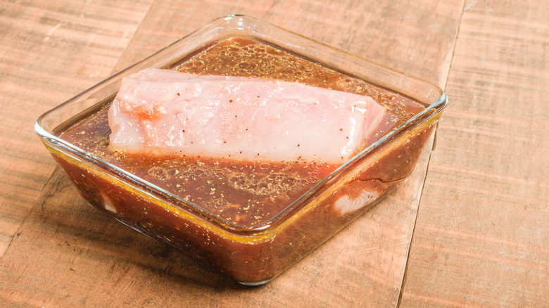 Tuna marinating in a container