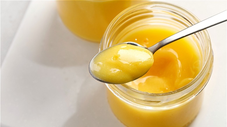 yellow lemon curd on spoon 