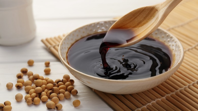 Spoonful soy sauce from bowl