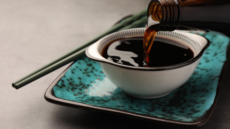 Pouring soy sauce into bowl