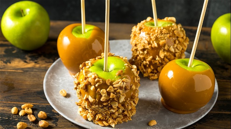 Green apples dipped in caramel and nuts