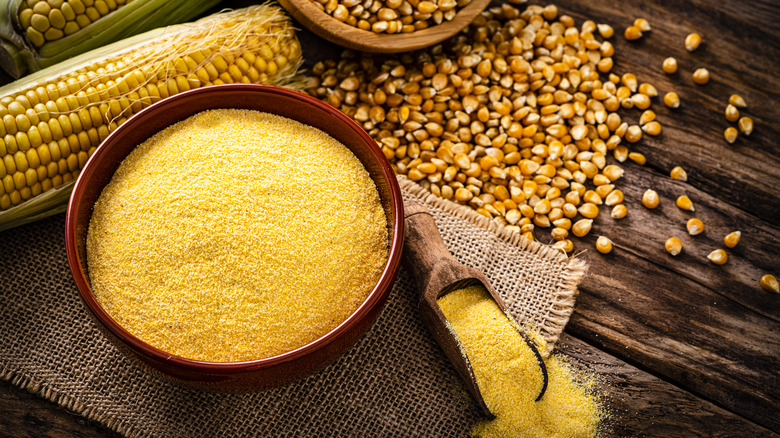 Dry grits in a red bowl with corn