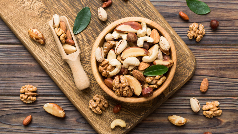 Mixed nuts in wood bowl with wood scoop