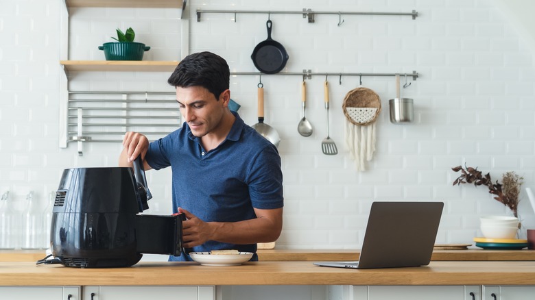 man using air fryer