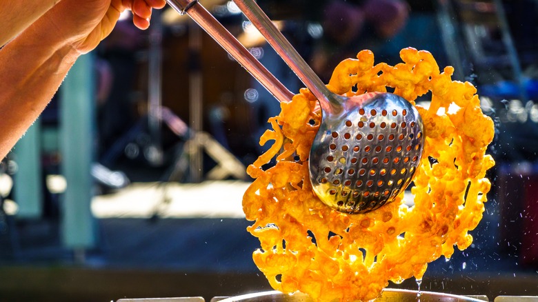 An individual cooking funnel cake