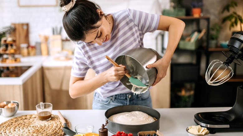 person making cheesecake