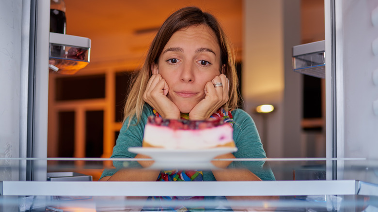 person looking at cheesecake