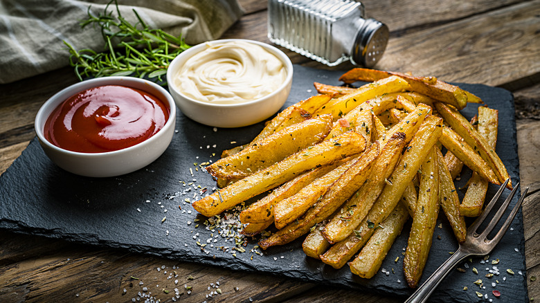 homemade golden french fries with ketchup and mayo