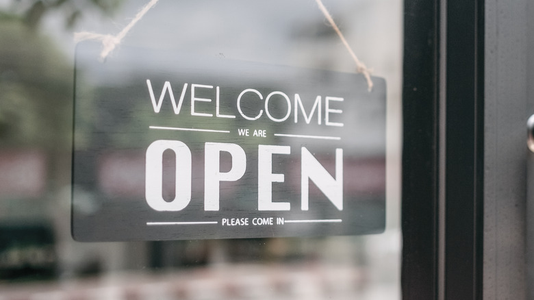 Grocery store entrance with 'open' sign