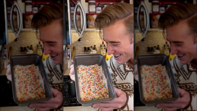 A person holding up a pan of ice cream bread