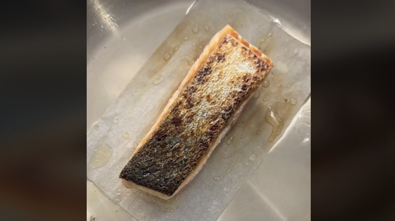 salmon cooking on parchment paper