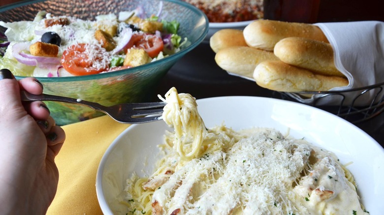 eating pasta from bowl at olive garden