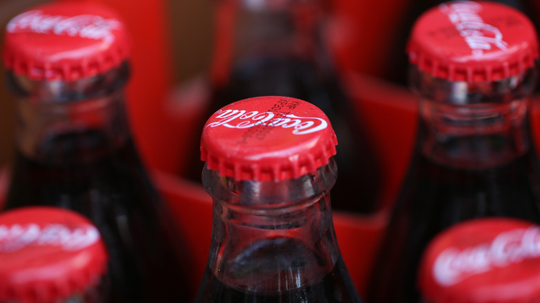 Glass Coca-Cola bottles with red bottle tops