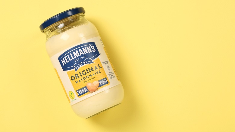 Bottle of Hellmann's mayonnaise on yellow background