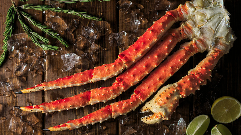 Large crab legs wooden surface.