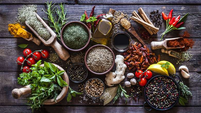 mixture of spices and herbs on wooden board