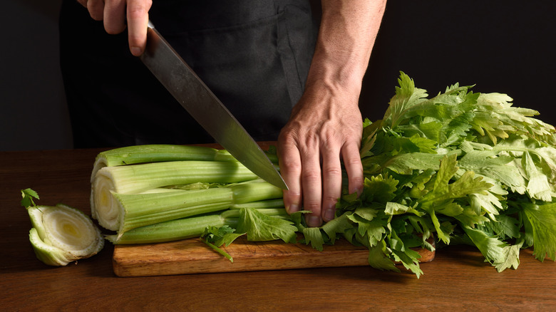 Person cutting celery with knife