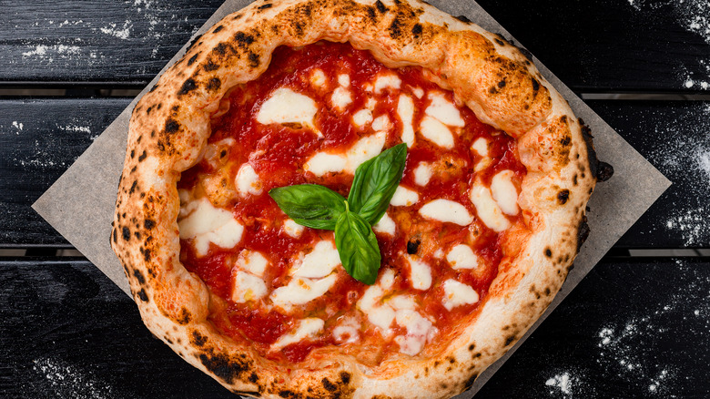 Margherita pizza on black table