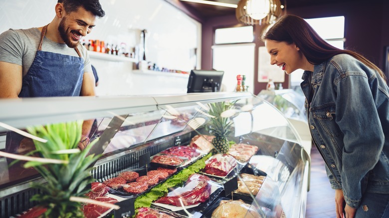 People shopping in a butcher store