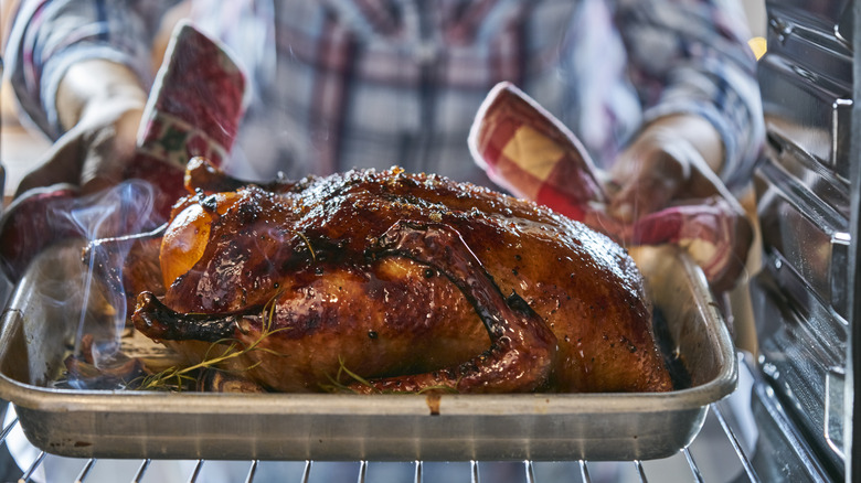 Roasted duck being removed from an oven