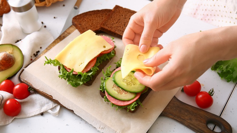 assembling a sandwich with tomato