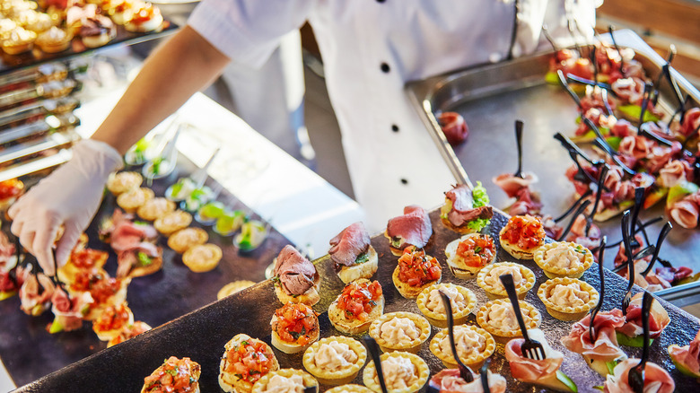 Server laying out food with gloves