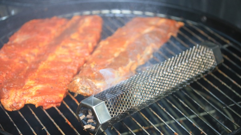 Smoked ribs on grill with pellet tube