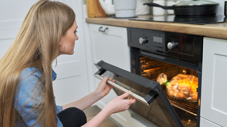 woman cooking bag-wrapped meat