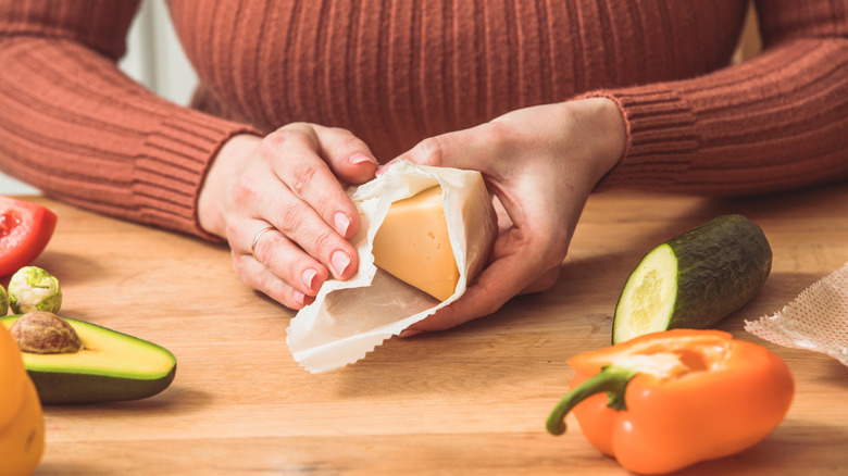 woman wrapping cheese