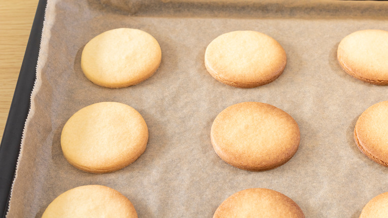 cookies on wax paper and baking sheet