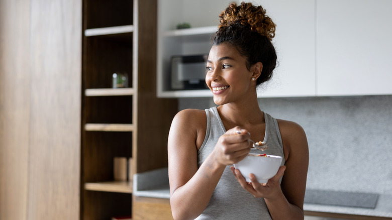 woman eating yogurt bowl