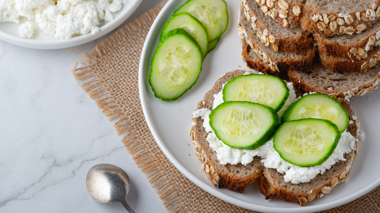 Cottage cheese on wheat bread with cucumber slices