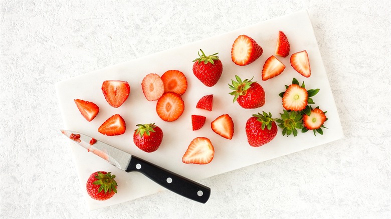 Chopped strawberries on cutting board